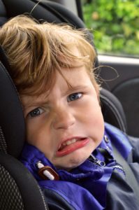 Young fella loving being driven around in the back of mammy's car